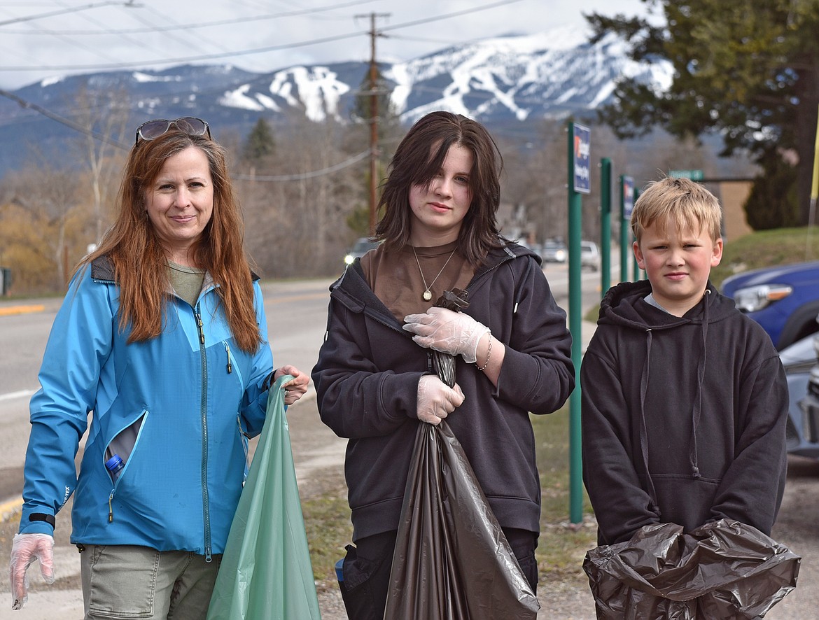 Diane Archie, Eleanor Archie and Beck Archie help to Clean the Fish along Spokane Avenue Saturday. (Julie Engler/Whitefish Pilot)