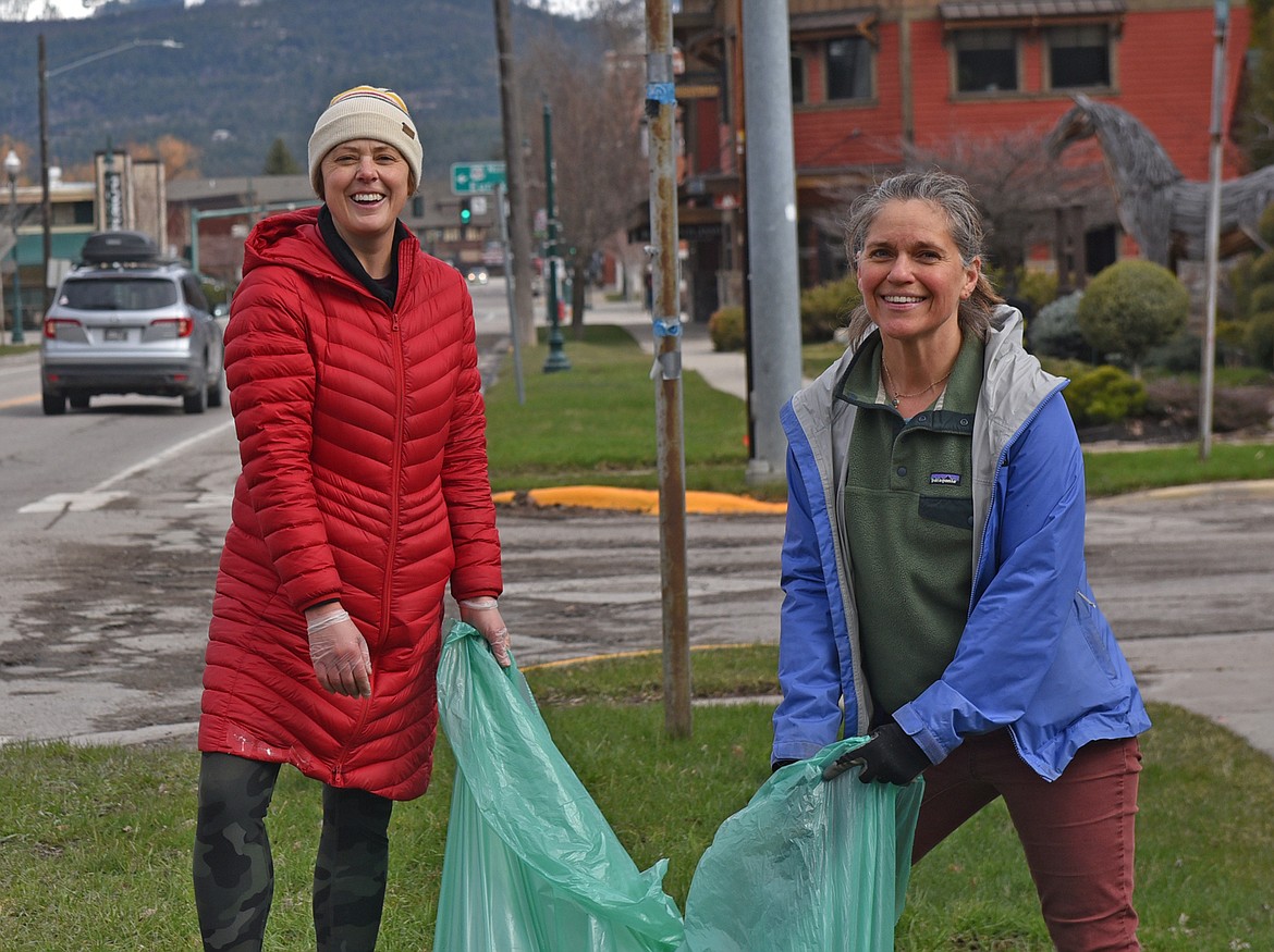 Jill Seigmund and Sara Bonds help to Clean the Fish along Spokane Avenue Saturday. (Julie Engler/Whitefish Pilot)