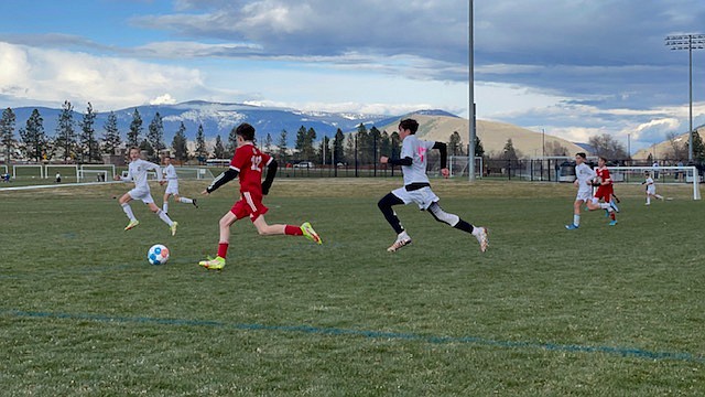 Courtesy photo
The Timbers FC 09 Boys Red soccer team coached by Jason Wyatt and Matt Fritts
played 3 friendlies this past weekend in Missoula, Mont. On Saturday afternoon, the Timbers beat GE SC 09 black 3-2. Timbers goals were by Rowan Wyatt assisted by Mason Taylor, and by Luke Fritts and Blake Wise. On Saturday evening the Timbers beat Billings Utd 09B pink 1-0. Kason Foreman scored on a corner kick from Creighton Lehosit, and Stefan Pawlik had the shutout in goal. On Sunday afternoon the Timbers beat the Missoula Strikers Red 6-1. Timbers goals were scored by Luke Fritts, Taylor Smith, Mason Taylor, Rowan Wyatt, Kason Foreman and Payson Shaw. Goalkeeping was shared by Stefan Pawlik and Grant Johnson. Pictured above is Jacob Melun (12) of the Timbers dribbling past a Billings United player in Saturday evening's game.