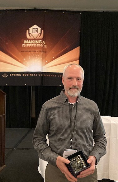 Moses Lake Realtor Kevin Burgess shows his Realtor of the Year award at the Washington Realtors Spring Conference on April 20.