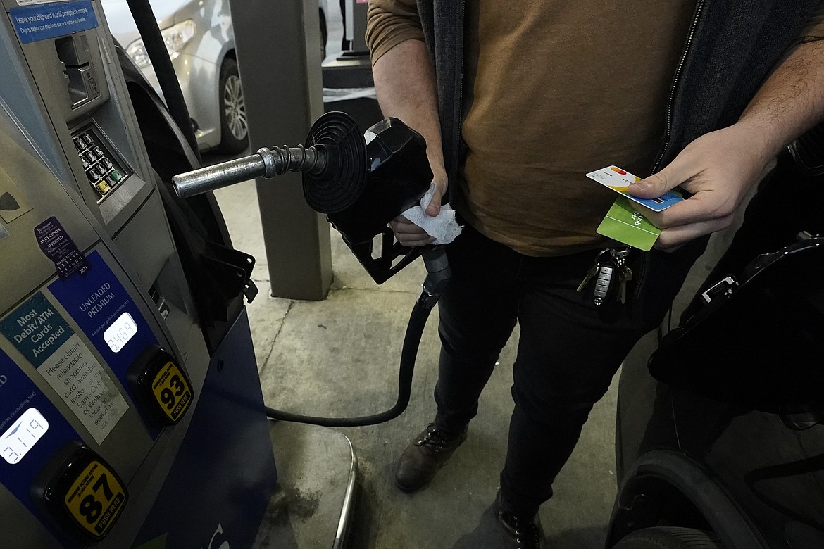 A customer prepares to pump gasoline into his car at a Sam's Club fuel island in Gulfport, Miss., Feb. 19, 2022.