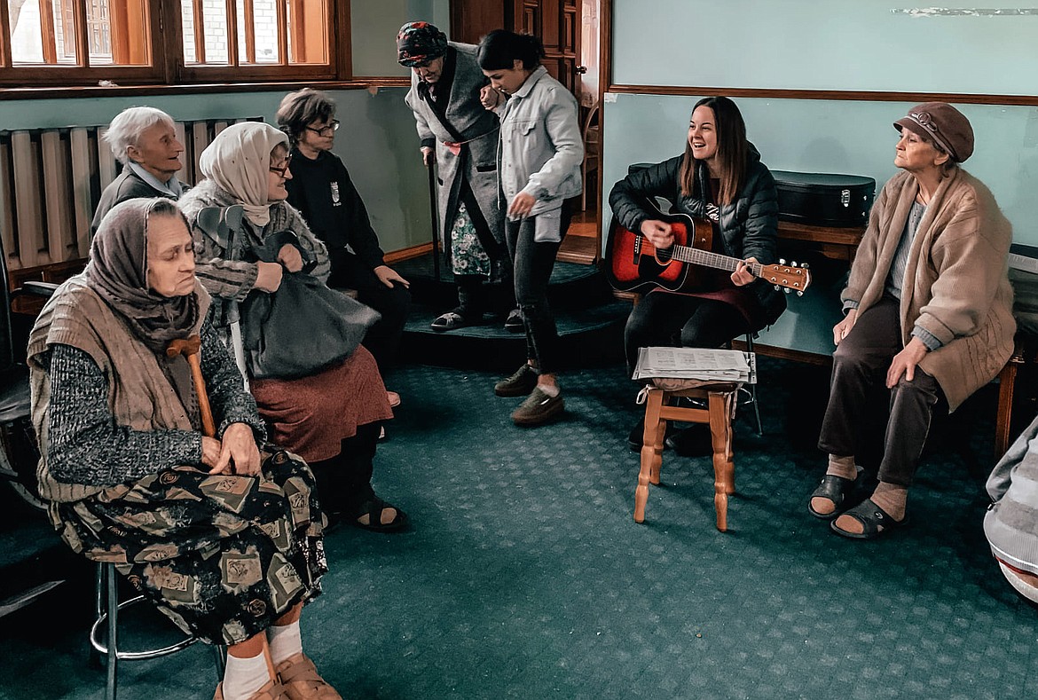 YWAM member Katariina Oja helps comfort elderly refugees in the Ukraine capital city of Kyiv earlier this month. (photo provided)