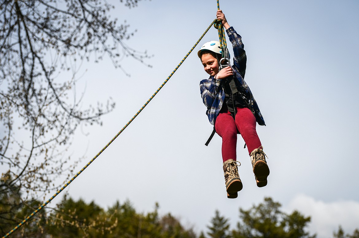 Edgerton Elementary third-grader Leise Connor is harnessed in and hoisted into the canopy of a nearby poplar tree by arborists from Trees for Life Montana during the Arbor Day celebration at Woodland Park in Kalispell on Friday, April 29. (Casey Kreider/Daily Inter Lake)