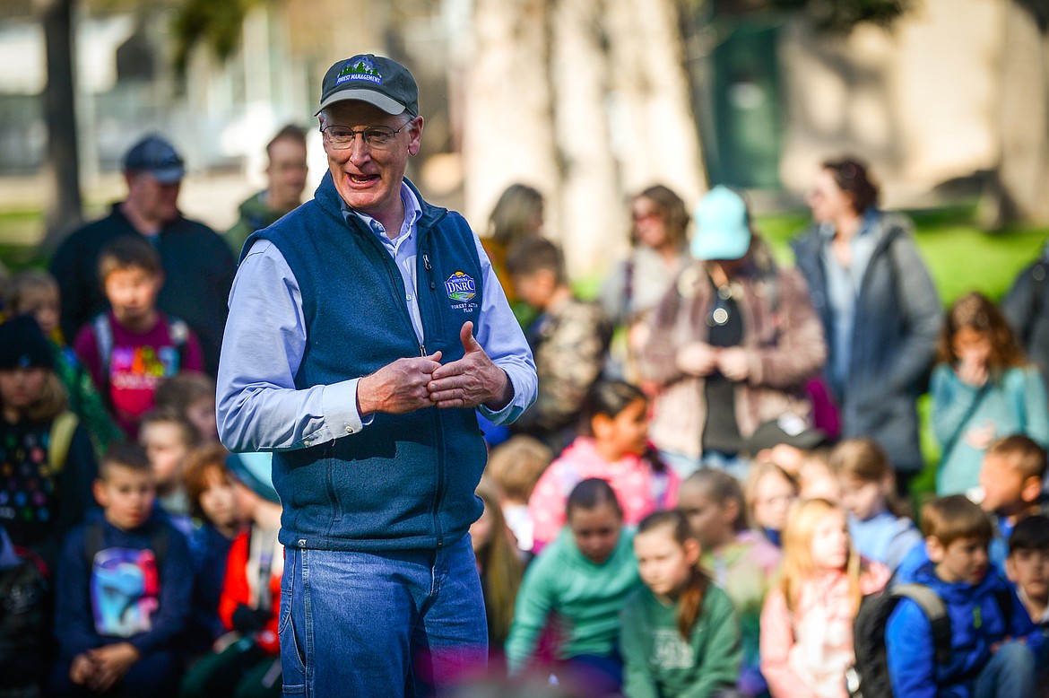 Greg Poncin, with the Montana DNRC, speaks to a group of third grade students during the Arbor Day celebration at Woodland Park in Kalispell on Friday, April 29. (Casey Kreider/Daily Inter Lake)