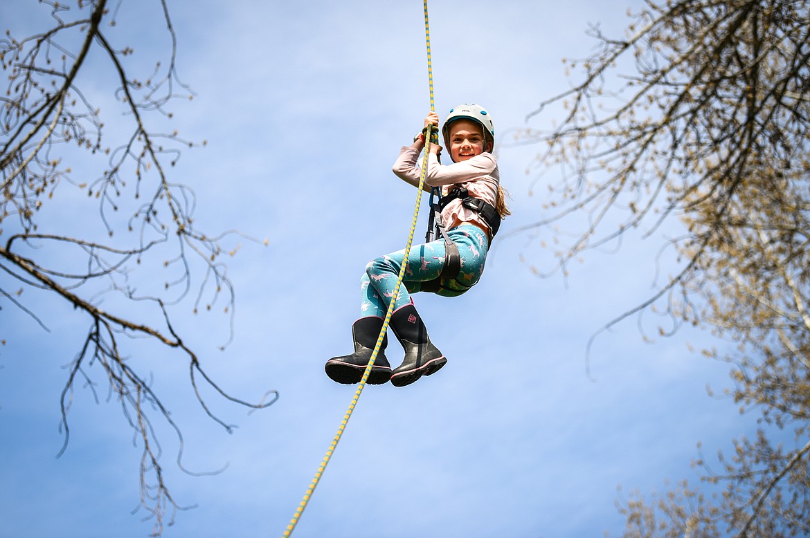 Edgerton Elementary third-grader Annie Lavin is harnessed in and hoisted into the canopy of a tree by arborists from Trees for Life Montana during the Arbor Day celebration at Woodland Park in Kalispell on Friday, April 29. (Casey Kreider/Daily Inter Lake)