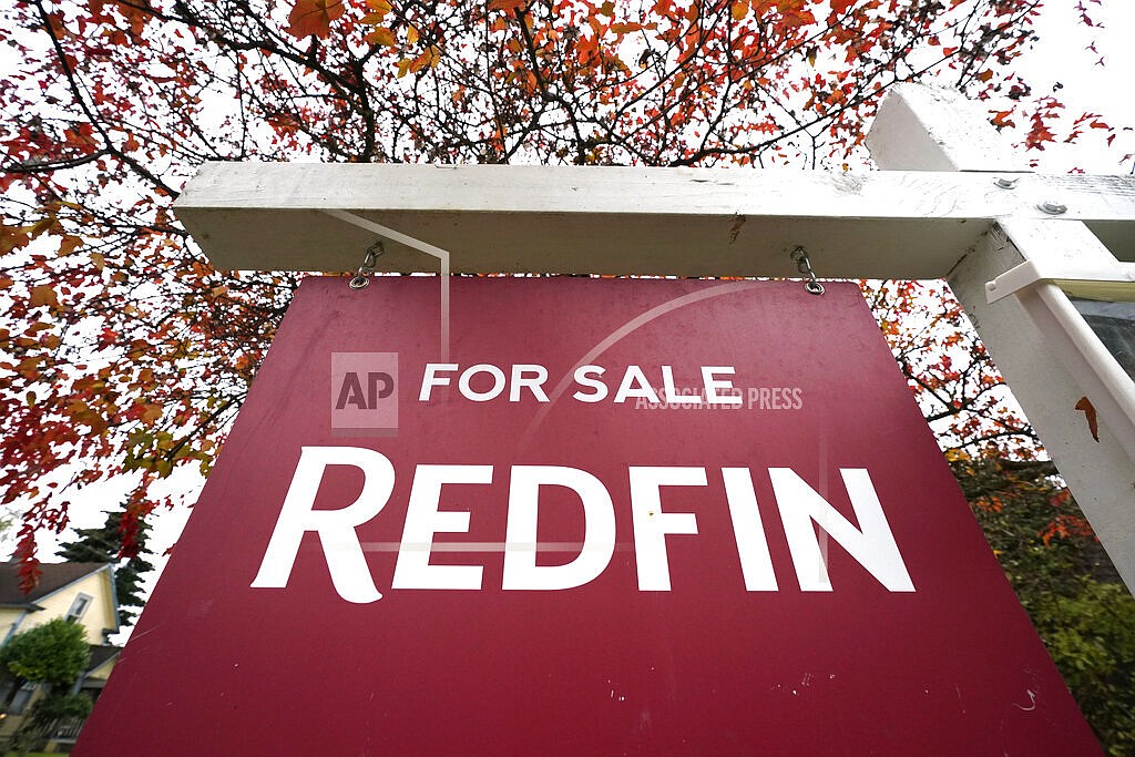 A Redfin "for sale" sign stands in front of a house on Oct. 28, 2020, in Seattle. The National Fair Housing Alliance on Friday, April 29, 2022, announced a settlement agreement to resolve a lawsuit against Redfin that will expand housing opportunities for consumers in communities of color in major cities. Under the agreement, Seattle-based Redfin will change its minimum housing price policy, alter other practices, and pay $4 million. (AP Photo/Elaine Thompson, File)