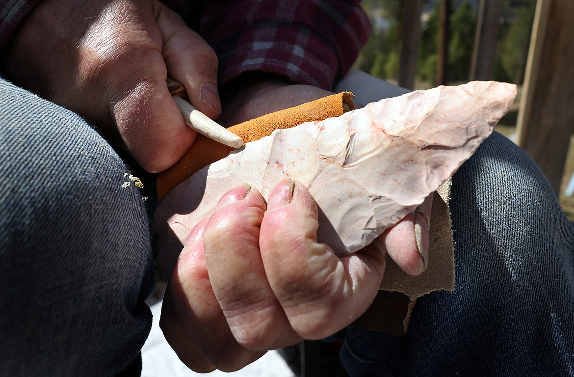 Tom Blaise uses a piece of antler to create the blade of a stone knife. (Jeremy Weber/Daily Inter Lake)