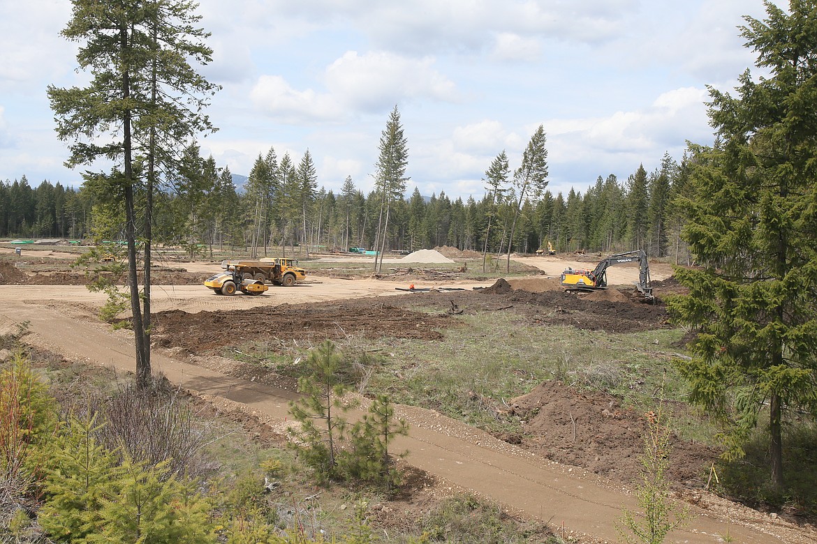 Workers clear land north of Lancaster Road and east of Government Way to prepare for construction of Hayden Canyon, a master-planned community of more than 1,500 homes ranging from cottages to manor estates.