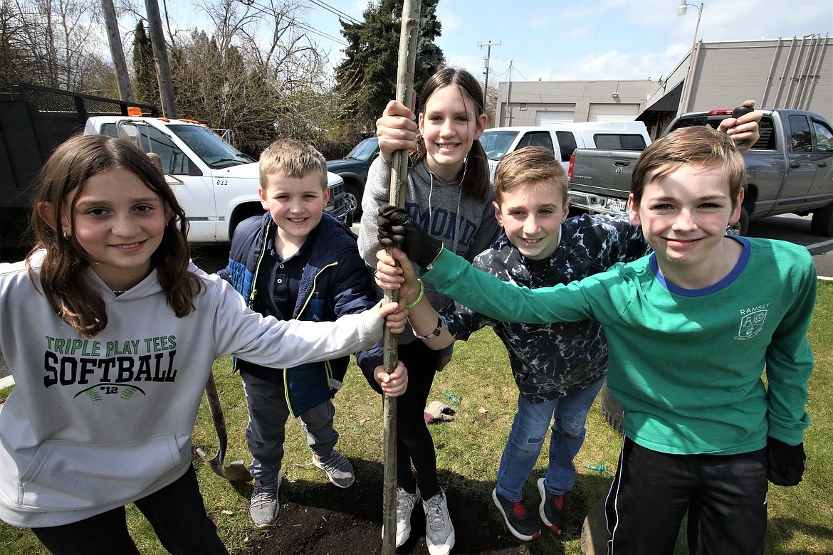 Ramsey Magnet School of Science students, from left, Kennedy Spencer, Michael O'Callaghan, Alaina Freed, Harrison Gabbert and Ryker Stevens, pose with the oak tree they planted on Friday at the East Sherman Pocket Park.