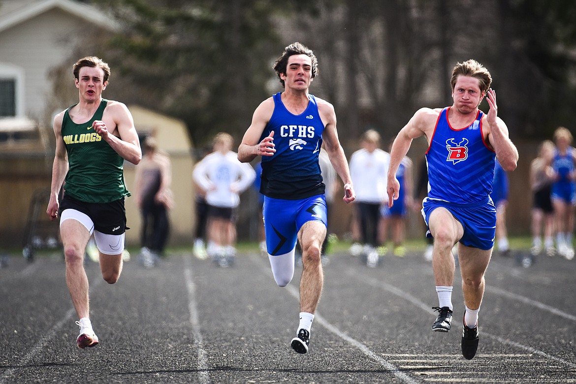 Whitefish's Bodie Smith, Columbia Falls' Jace Duval and Bigfork's Joseph Farrier compete in the boys 100 meter dash at the Whitefish ARM Invitational on Saturday, April 30. (Casey Kreider/Daily Inter Lake)