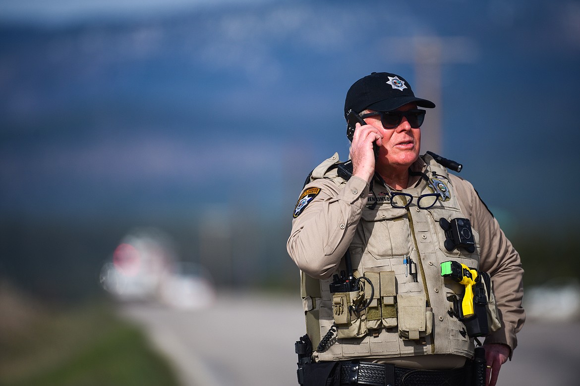 A deputy with the Flathead County Sheriff's Office near the scene of a small plane crash in the West Valley on Saturday, April 30. (Casey Kreider/Daily Inter Lake)