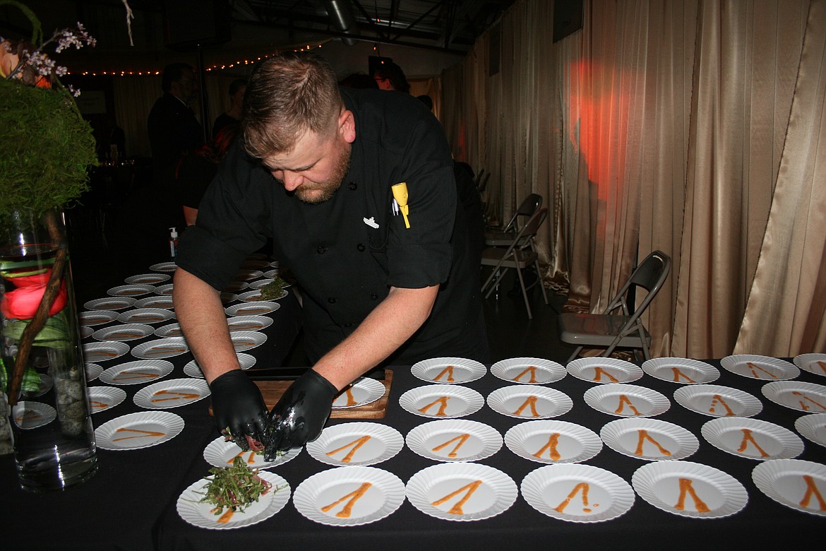 Tim Edwards plates an entree prior to the Samaritan Healthcare Foundation’s Bourbon & Bowties fundraiser Friday at the Grant County Fairgrounds. Edwards is a chef at Tendrils restaurant near Quincy.