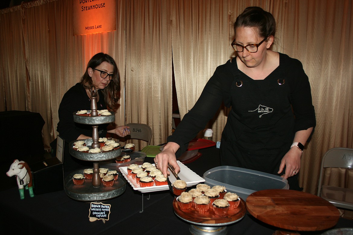 Cow Path Bakery owner Janice Baginski (right) and assistant Linda Sierra (left) prepare their dessert table at Bourbon & Bowties.