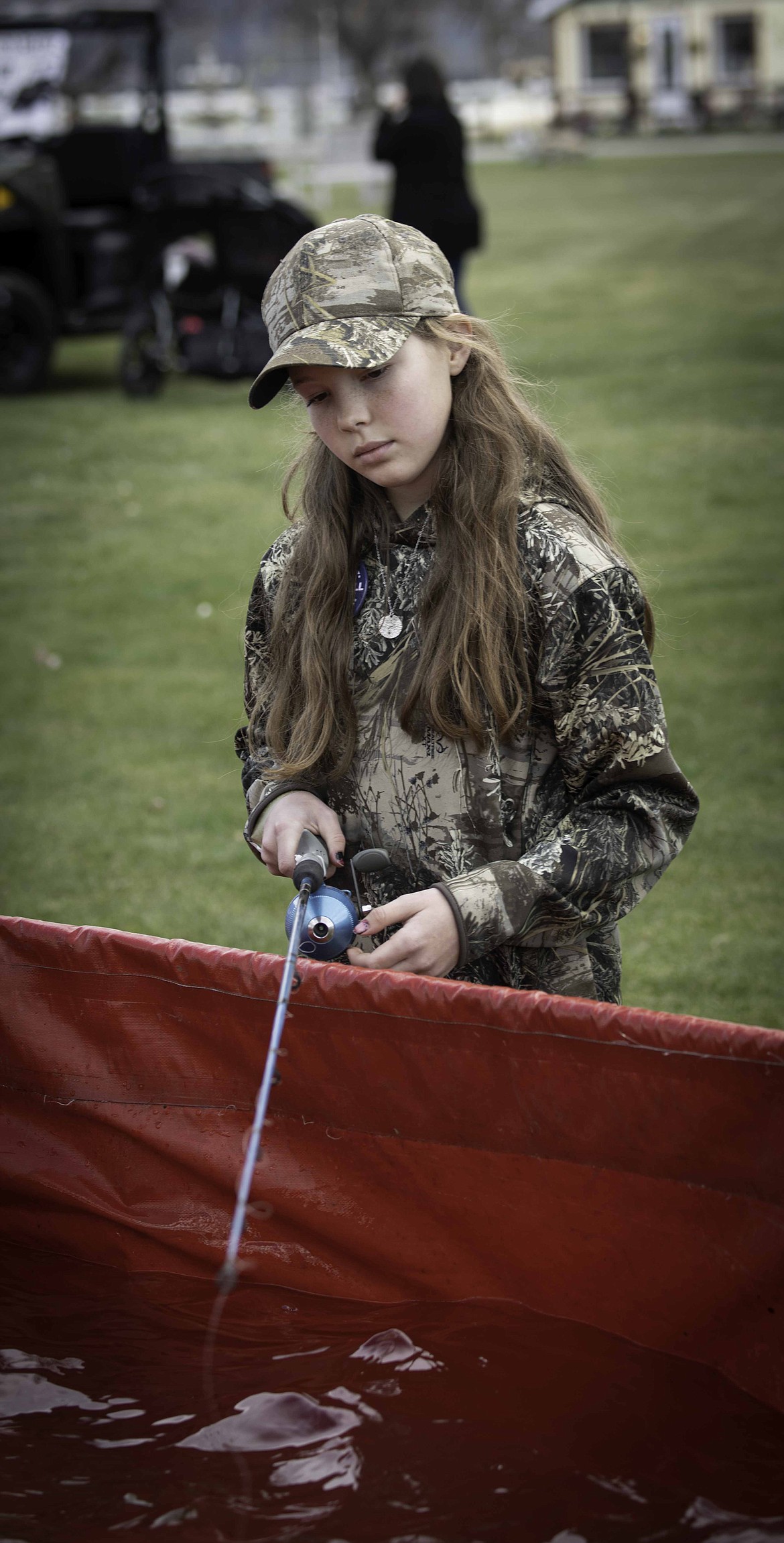 Lily Kandel at the Kids Fishin’ Pond during the Montanan Sportsmen for Wildlife Feast & Fun Pig Roast at the Sanders County Fairgrounds. (Tracy Scott/Mineral Independent)