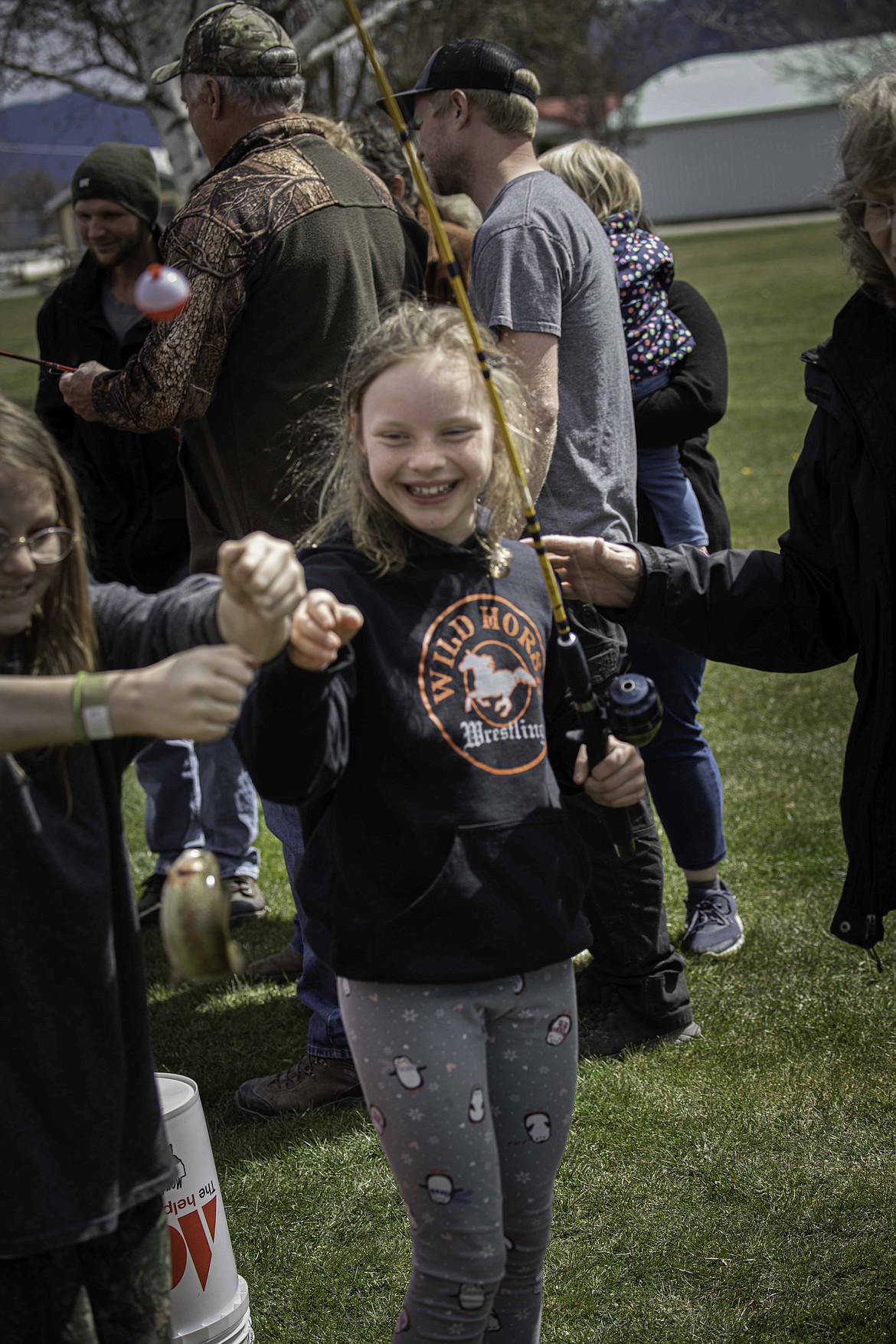 With a big smile, Emmy Russel shows off her catch at the Montana Sportsmen For Wildlife Fundraiser where the Kids Fishin’ Pond was stocked with trout from a private fish hatchery near St. Ignatius. (Tracy Scott/Valley Press)