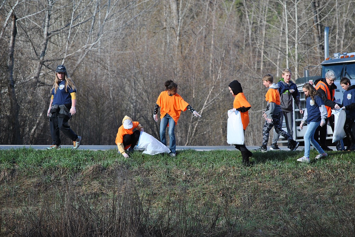 On April 22, Earth Day the town of St. Regis was spruced up and rid of trash by brightly colored class groups on the cold and sunny morning. These bright orange 5th graders walked along the north side of Mullan Gulch road picking up debris. Grades K-12 from St. Regis School were split up and designated other sections of road, or areas to clean. The efforts were led by senior Baylee Pruitt, who put the event together as part of her senior project and her ongoing work with the Youth Group of New Day Fellowship. Organizers of the annual Trail Rail Run provided neon shirts for students to wear and extra gloves. And the St. Regis Travel Center donated a refreshing drink to each student who gathered garbage that day. (Amy Quinlivan/Mineral Independent)