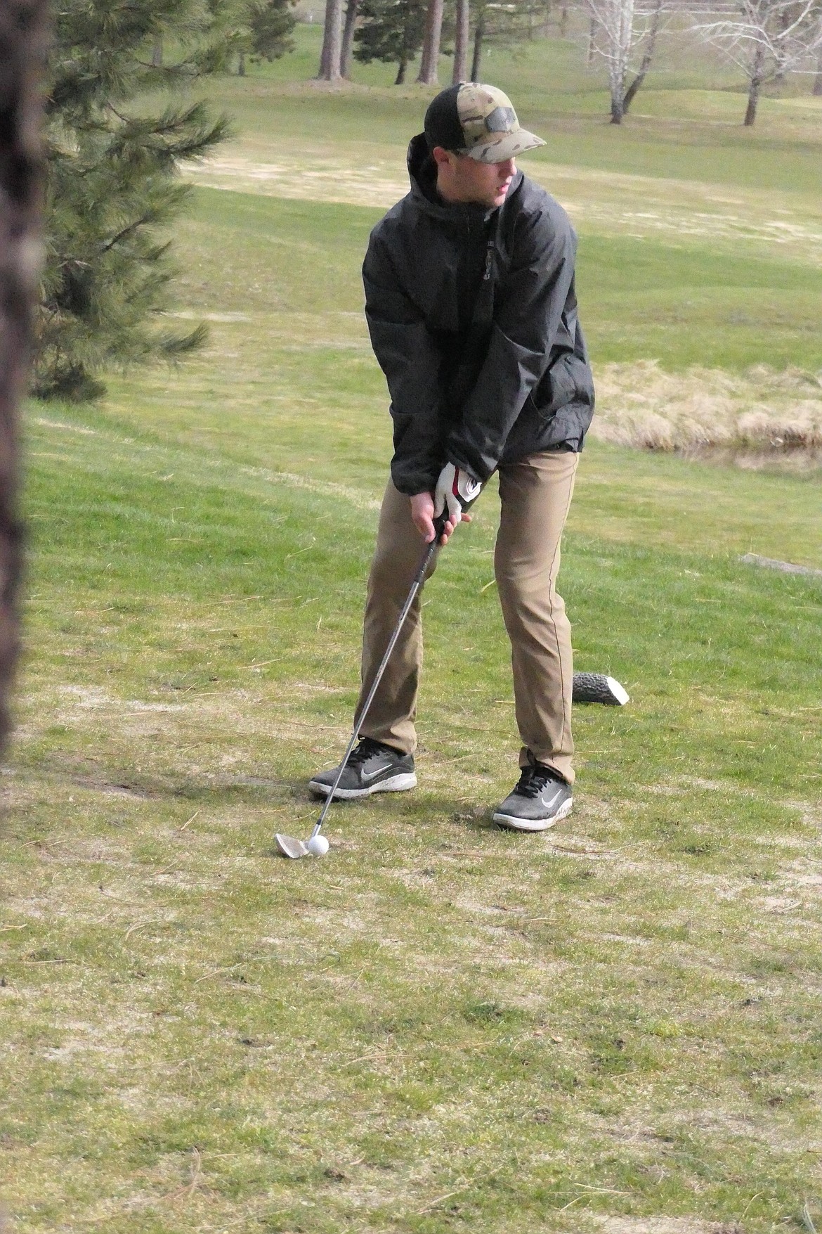 St. Regis junior Caleb Ball pitches toward the green on his way to an 18-hole total 96 at the St. Regis Golf invitational at Trestle Creek Golf Course.   (Chuck Bandel/VP-MI)