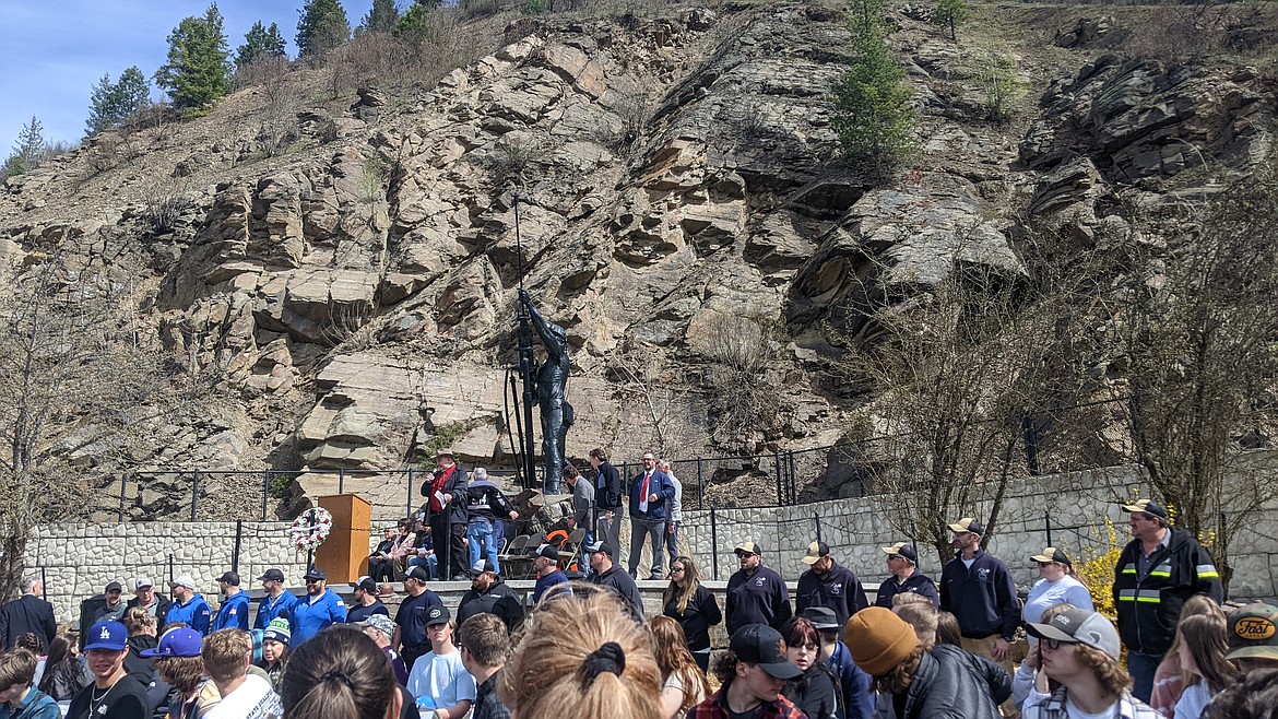 Current mine rescuers line up in front of the Sunshine Miners Memorial Statue.
