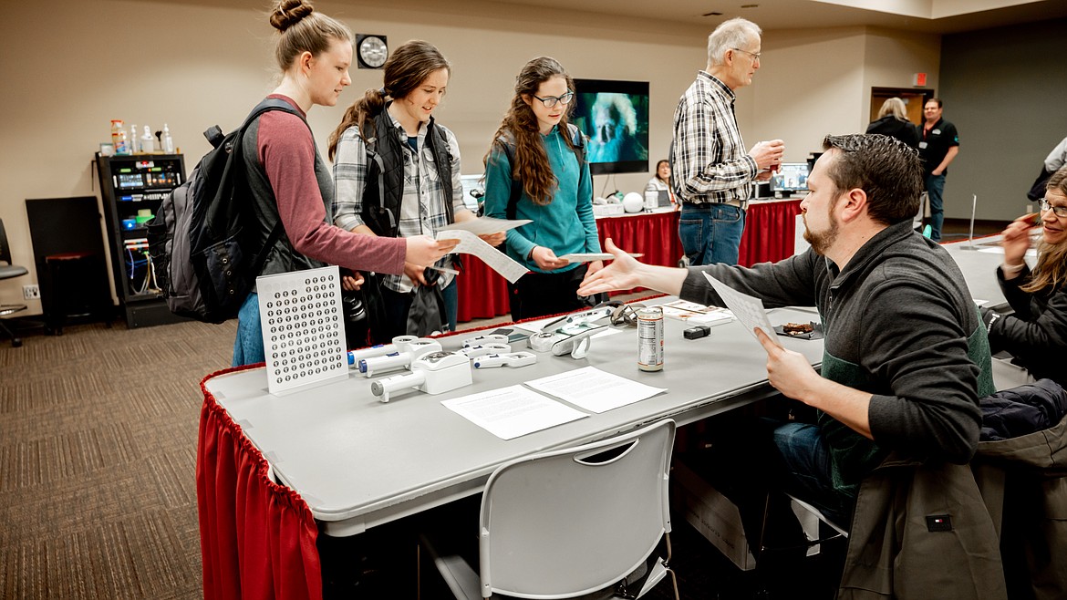 Tyler Kuisti of the Idaho Commission for the Blind and Visually Impaired shares information with North Idaho College students Elisa Osborn, left, Janae Osborn and Faith Osborn during the third annual Pave the Way to Global Accessibility Awareness Day on April 20 in the Edminster Student Union Building. Photo courtesy of Megan Snodgrass/North Idaho College