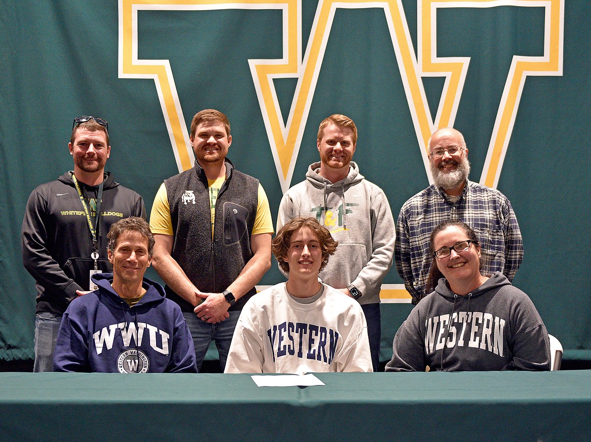Whitefish senior Gabe Menicke recently signed a letter of intent to join the Western Washington track and field team. Menicke is pictured with his parents and coaches on signing day, April 29. (Whitney England/Whitefish Pilot)