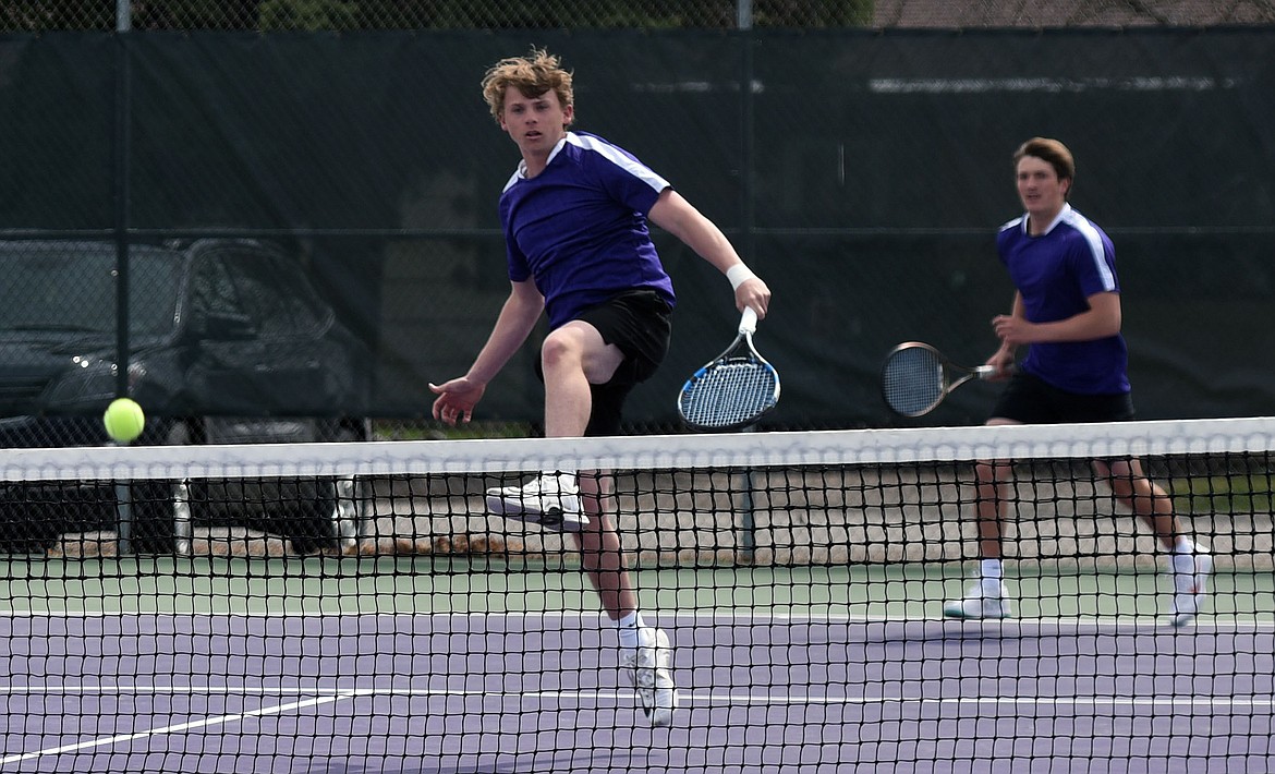 Polson's Trent Wilson returns a shot in front of teammate Owen McElwee during their 6-3, 6-2 win over Cade Morgan and Cody Schweikert of Columbia Falls. (Scot Heisel/Lake County Leader)