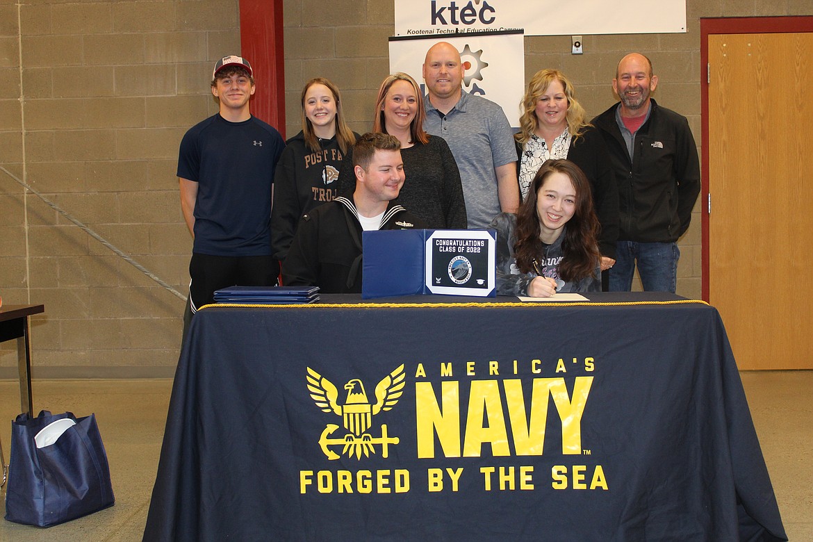 KTEC/Post Falls High senior Makayla Bole signs a letter of intent with the Navy on Tuesday. She has enlisted as a hospital corpsman. Also pictured: Navy recruiter Austin Crow, seated. Standing, from left: Makayla's siblings Tyler and Lily Bole, mom and stepdad Lacie and Jake Salisbury and grandparents Kecia and Tom Siegel.