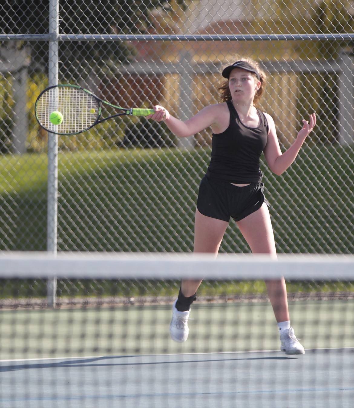 MARK NELKE/Press
Madi Nesbit of Lake City hits a return to Audrey Judson of Coeur d'Alene in their No. 1 girls singles match Tuesday at Lake City High.