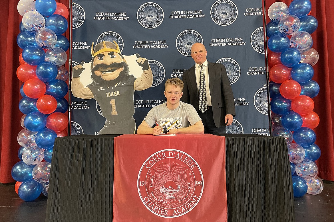 Coeur d'Alene Charter Academy senior Cooper Hancock signed a letter of intent to attend the University of Idaho. He is pictured here April 14 with Principal Dan Nicklay.