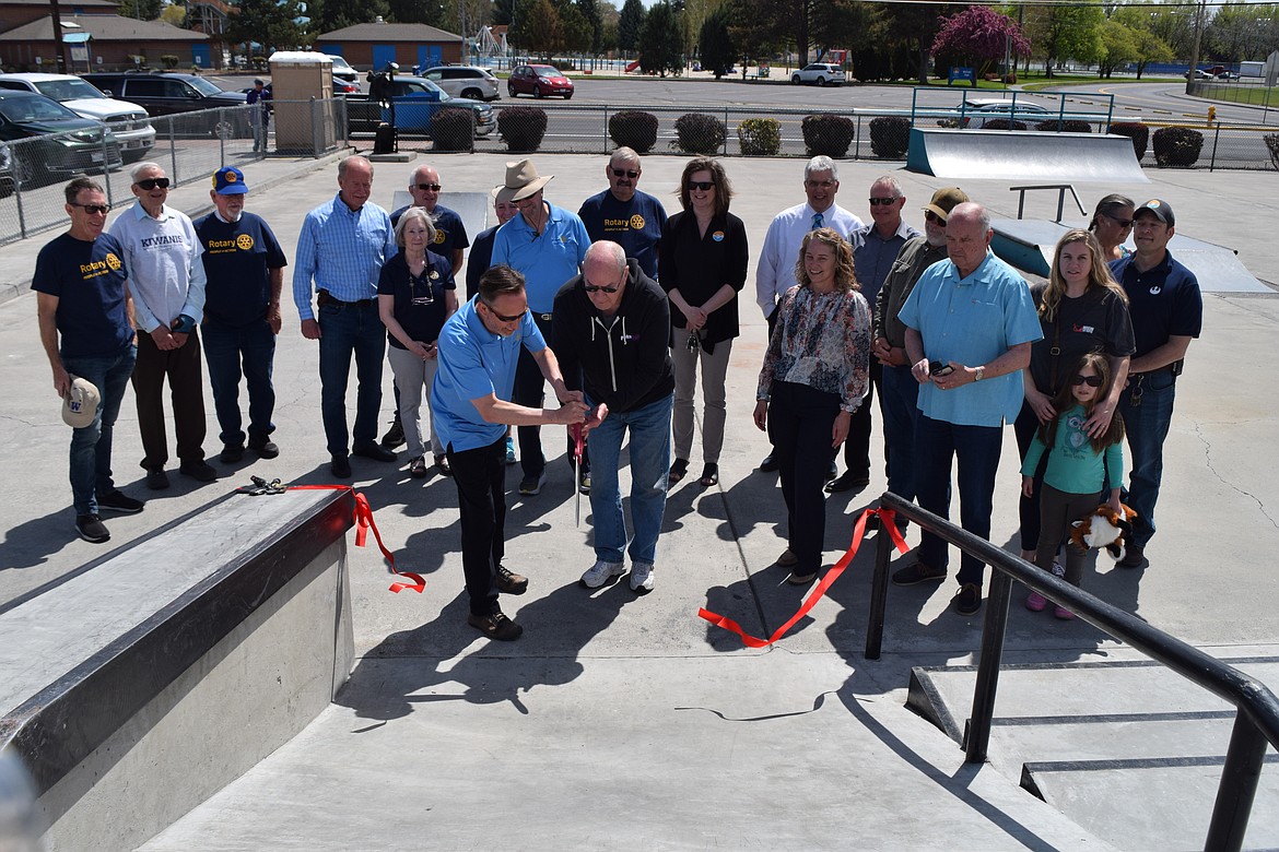 Steve Ausere (left), past president of the Rotary Club of Moses Lake, and Mayor Dean Hankins cut the ribbon to inaugurate the new additions to the Moses Lake Skate Park on Wednesday.