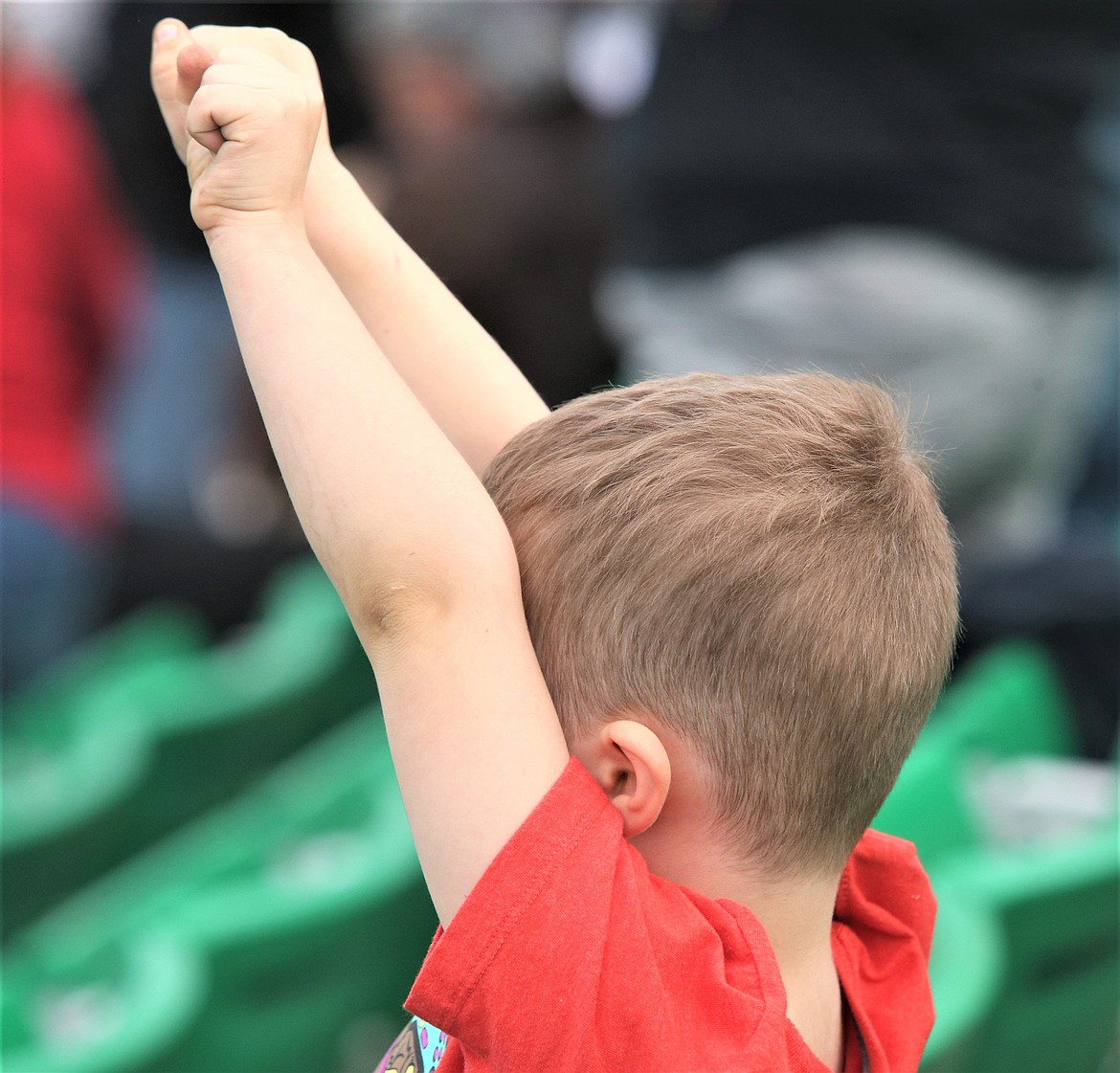 A boy raises his arms during at The People's Convoy rally at Stateline Speedway on Wednesday.