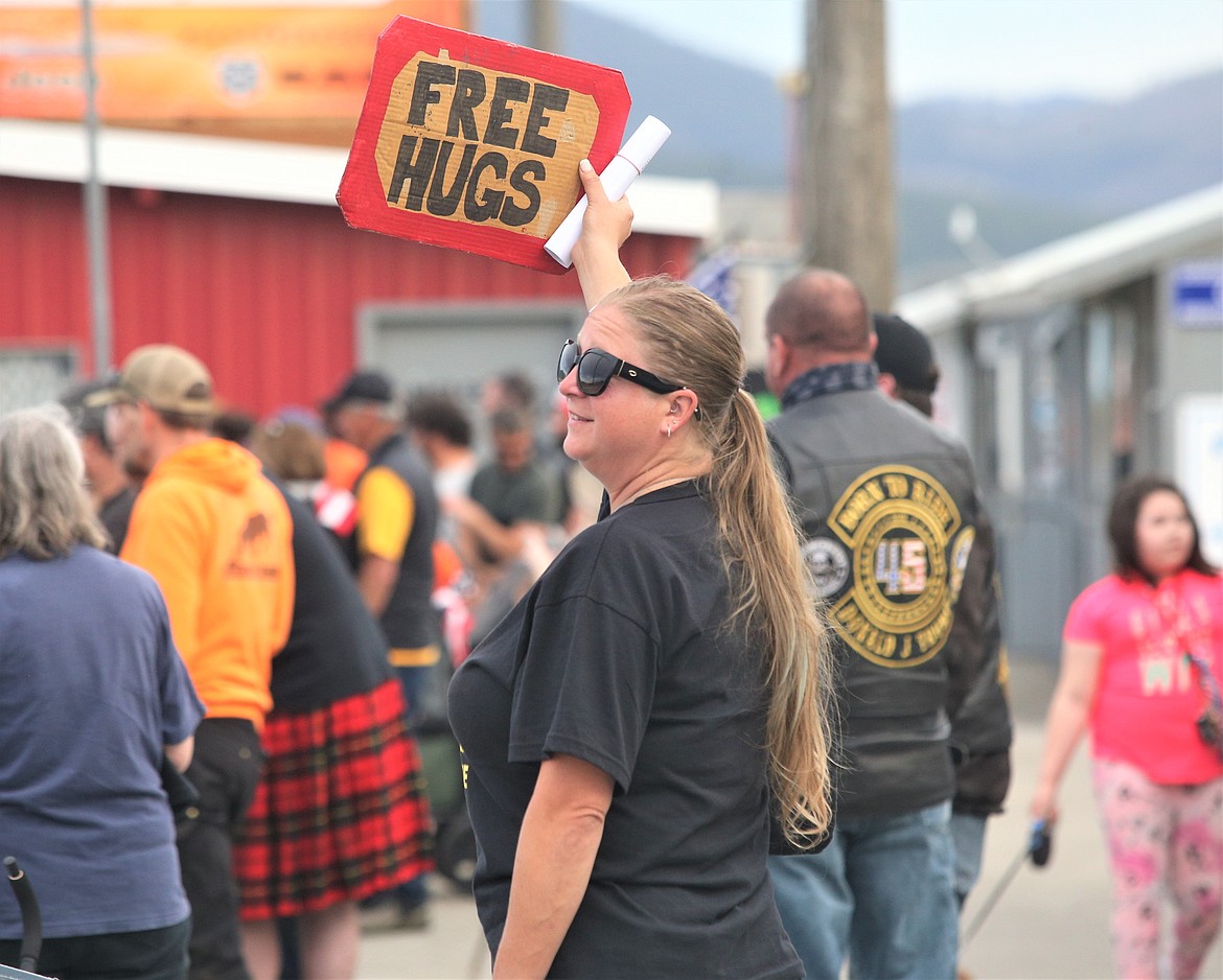 "Liberty" Lauren Holly holds her "Free Hugs" sign at Stateline Speedway on Wednesday.