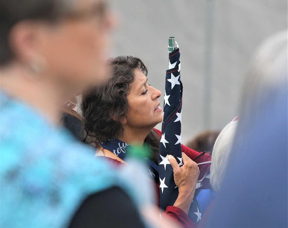 A woman sings along with the Star Spangled Banner during Wednesday's People's Convoy rally.