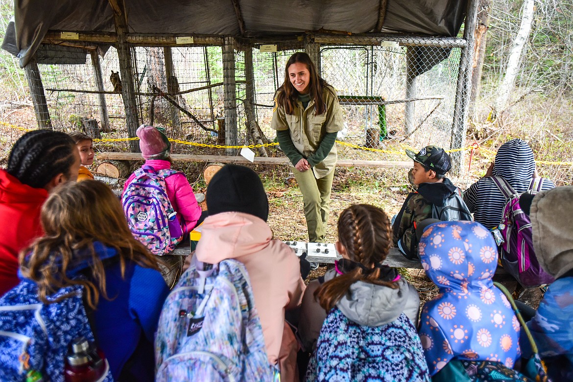 Anna Masino, an AmeriCorps member with Montana State Parks, speaks to a group of fifth-grade students from Russell Elementary School about a variety of owls from Montana Wild Wings on display at the wildlife station of the Family Forestry Expo at Trumbull Creek Educational Forest in Columbia Falls on Friday, May 6. (Casey Kreider/Daily Inter Lake)