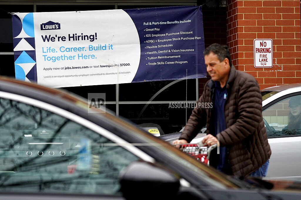 A hiring sign is displayed at a home improvement store in Northbrook, Ill., Thursday, May 5, 2022. America’s employers added 428,000 jobs in April, extending a streak of solid hiring that has defied punishing inflation, chronic supply shortages, the Russian war against Ukraine and much higher borrowing costs. (AP Photo/Nam Y. Huh)