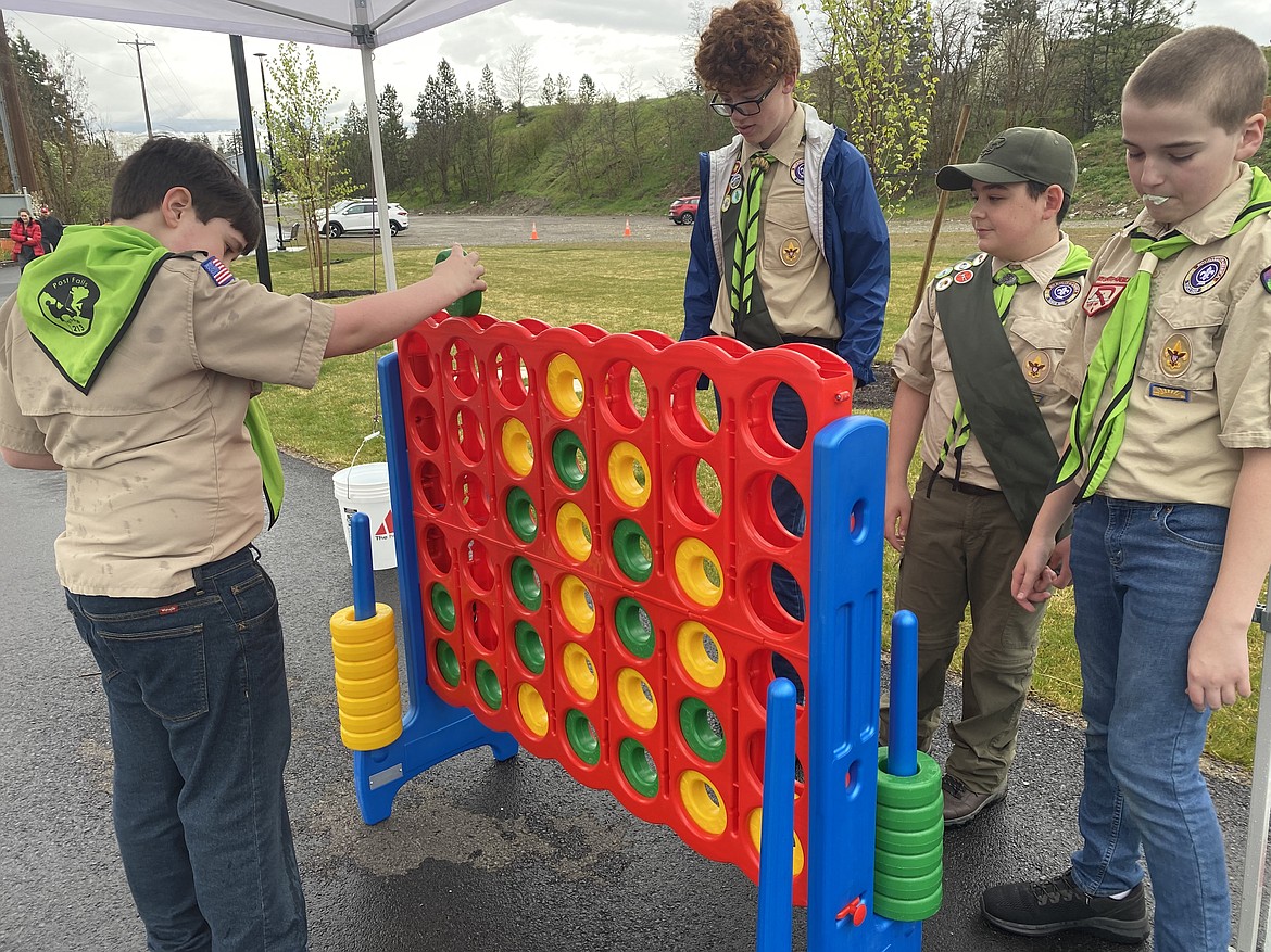 Boy Scout 213 presented the colors at the Landings Park dedication Friday. Prior to the ceremony they took time to play a few games. From left: David Anfang, Oakley Lohman, Wyatt Laiva and Matthew Anfang.