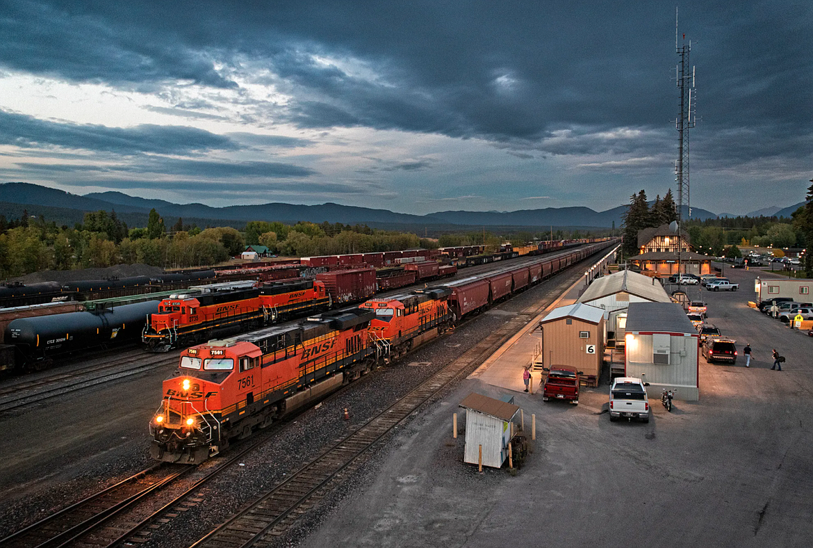 A BNSF Railway grain train departs Whitefish in September 2018, passing the office where train crews report for duty. (Photo by Justin Franz)