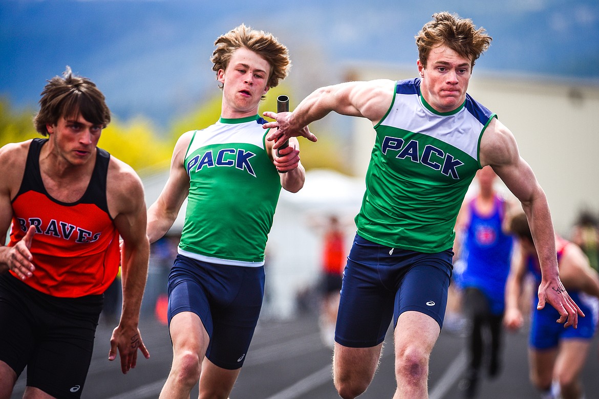 Glacier's Xavier Stout takes the baton from Connor Sullivan in the boys 4x100 meter relay at the Archie Roe Invitational track meet at Legends Stadium on Saturday, May 7. Also running legs on the Wolfpack's winning relay team were Jake Turner and Jackson Hensley. (Casey Kreider/Daily Inter Lake)