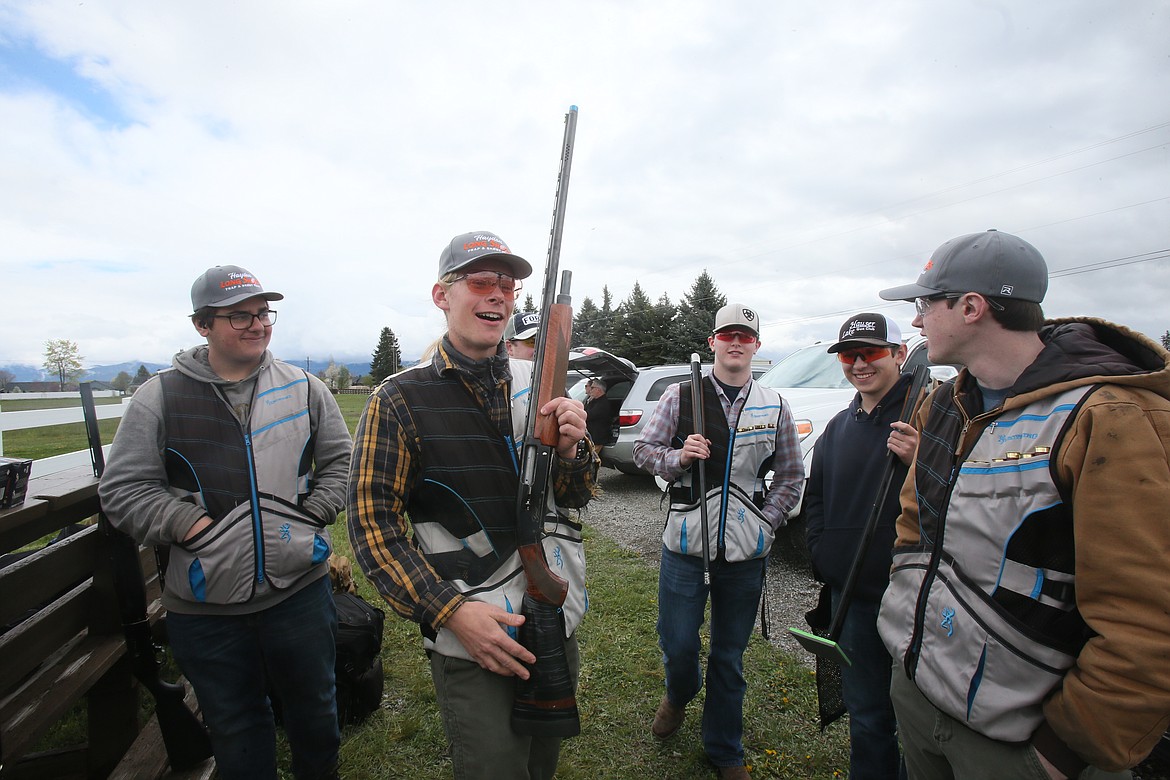 Coeur d'Alene High School junior Taylor Izzard, 16, center, discusses how he uses his grandfather's famous Browning Gold semi-automatic shotgun during the Idaho State Youth Shooting Sports Championship on Saturday.