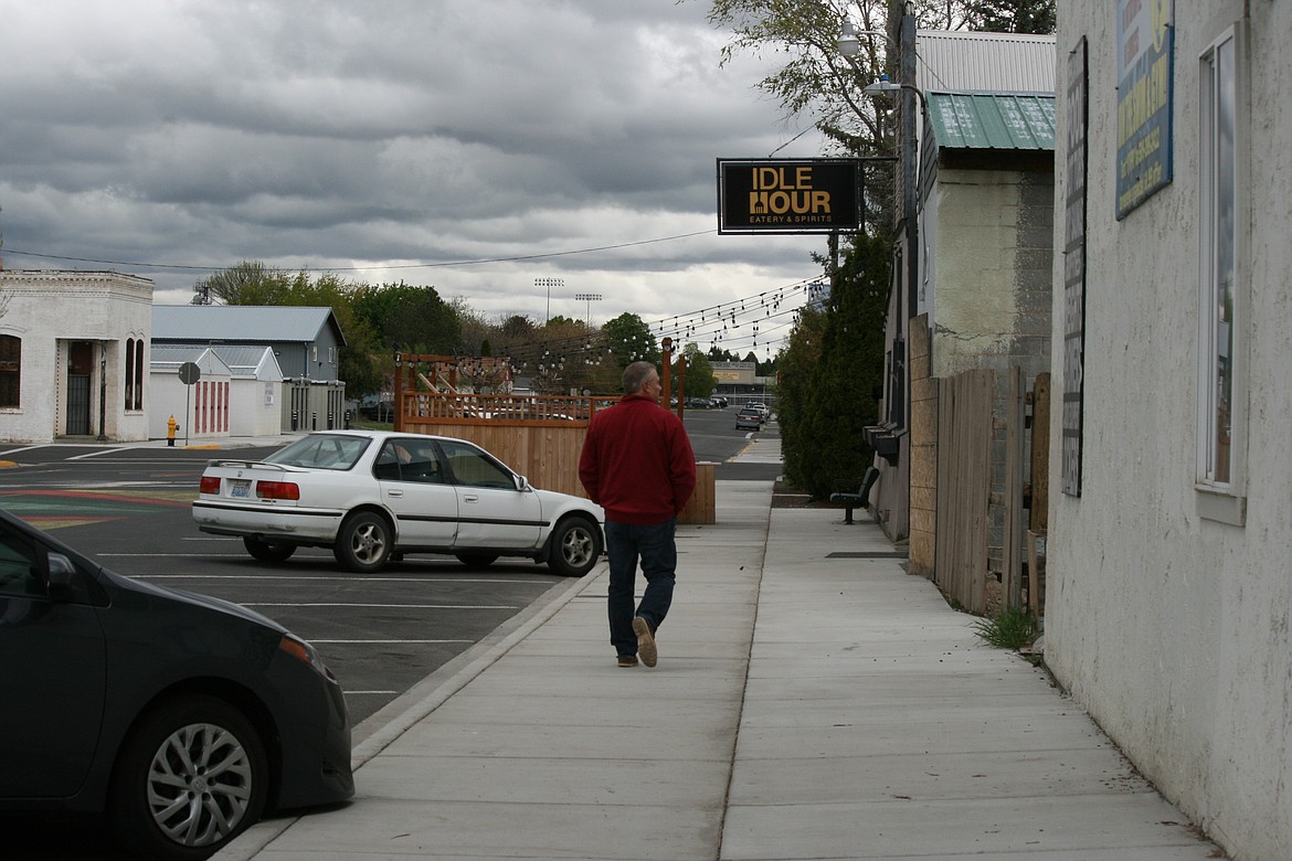 A pedestrian walks down B Street in Quincy, part of the area covered by a revitalization plan focusing on the downtown district.