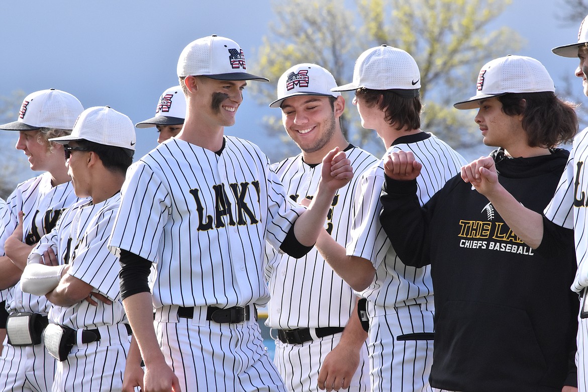 MLHS Senior Avery Passey goes down the line giving hugs and knuckles to his teammates during the senior recognition ceremony on Friday.