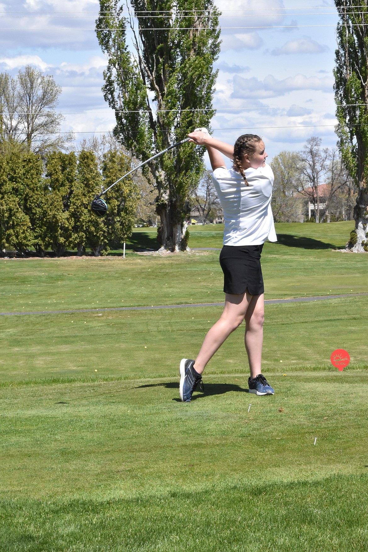 Freshman Eastlyn Cranston tees off at the Moses Lake Golf Club on Monday.