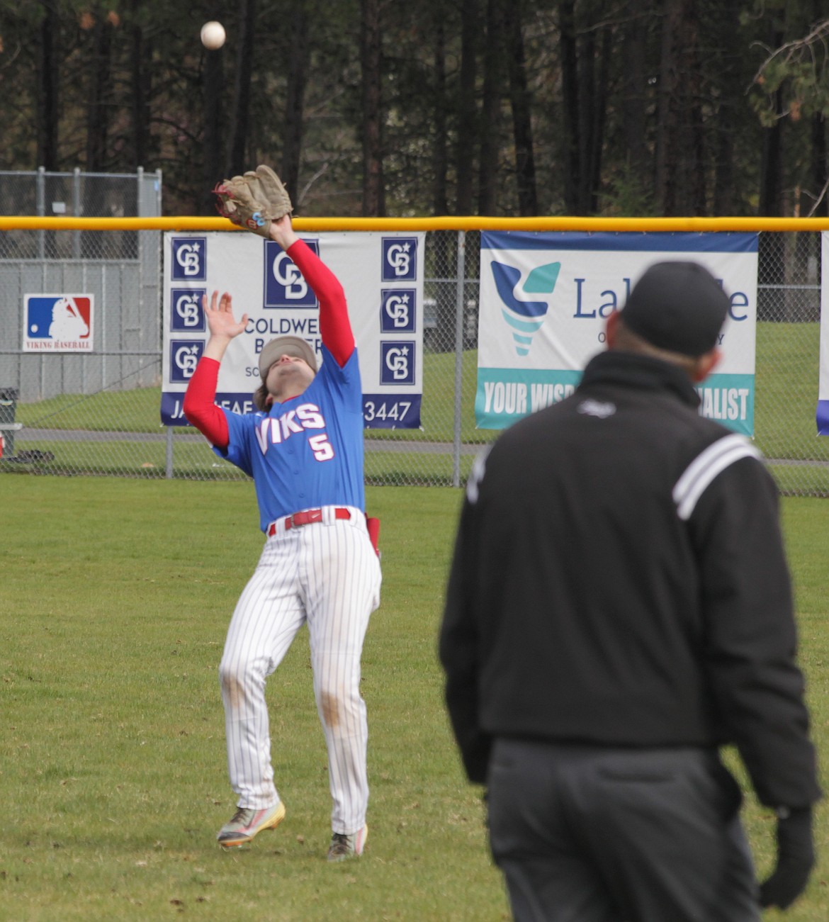 MARK NELKE/Press
Coeur d'Alene second baseman Evan Mallory backpedals into short right field to catch a popup against Lake City on Monday at Ted Page Field.