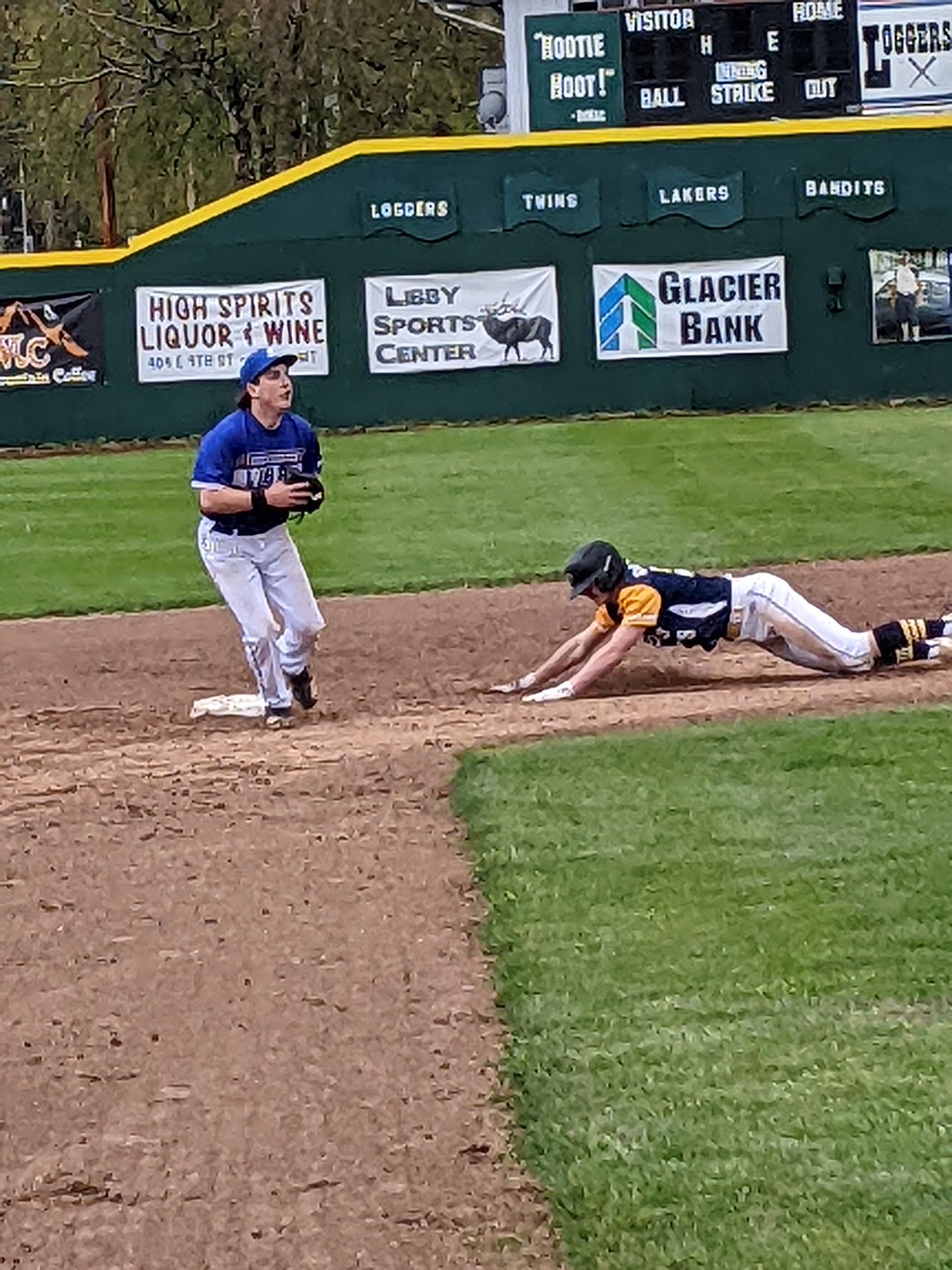 Riverdogs outfielder Tanner Day slides into second base ala Pepper Martin style during this weekend's action in the Libby Wooden Bats tournament.  (Photo by Jon Zigler)