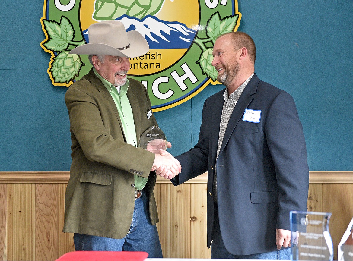 Glacier Hops Ranch CEO Tom Britz accepts the Exporter of the Year award from Brent Donnelly, SBA Montana District Director. (Whitney England/Whitefish Pilot)