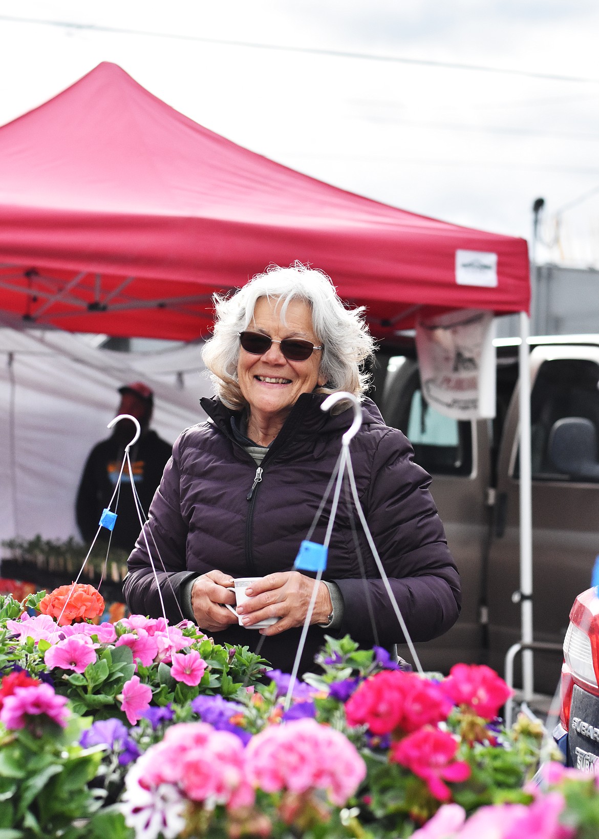 Kathy Sykes of Moiese Valley Greenhouse set up shop at the first Polson Farmers Market of the season Friday. The market is open from 9 a.m. to 1 p.m. each Friday on Third Avenue West in front of The Cove Deli. The Ronan Farmers Market kicks off its season May 19, and the Mission Falls Market in St. Ignatius begins May 20. (Emily Lonnevik/Lake County Leader)