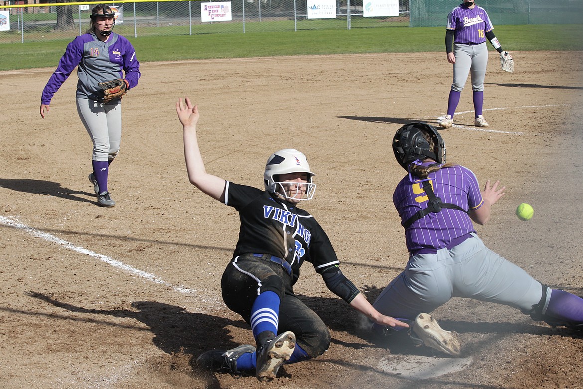 MARK NELKE/Press
Matea Dorame of Coeur d'Alene slides home safely in the second inning as Lewiston catcher Taryn Barney awaits the throw Tuesday in the 5A Region 1 softball championship game at Coeur d'Alene High's Larry Schwenke Field.