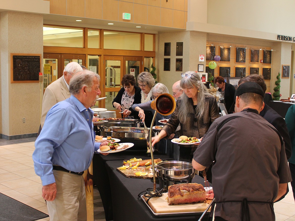 Attendees fill their plates at Cellarbration! For Education last Saturday. The fundraiser banquet featured salmon and prime rib catered by Michael’s On The Lake.