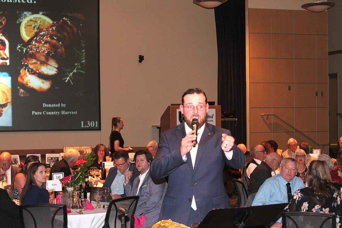 Auctioneer Jacob Barth sells items at Cellarbration! For Education Saturday evening with a machine-gun-like patter. The fundraiser at Big Bend Community College brought in about $168,000 for student scholarships.