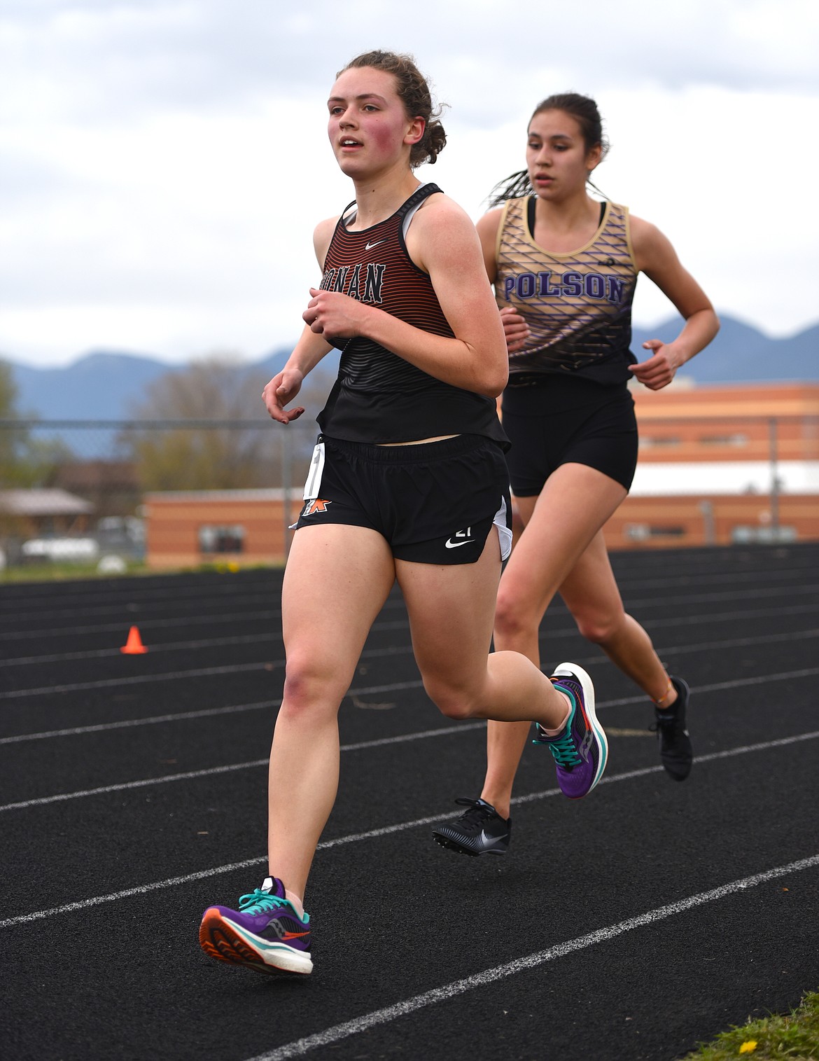Olivia Heiner of Ronan and Ashtyn Wagner of Polson finished 1-2 in the girls 3200. (Scot Heisel/Lake County Leader)