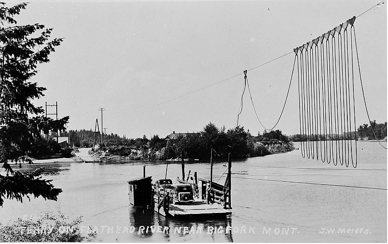 Holt Ferry (electrified) on Flathead River, looking south toward Kehoes Shop.  Photo by J.J. Meiers. (Elmer Sprunger Collection)